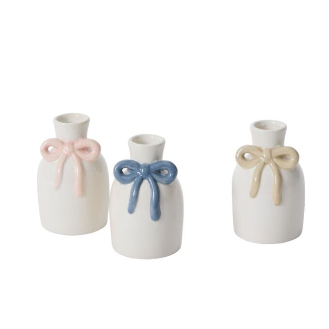 Three small white vases with colorful hand painted bow decorations on a white background