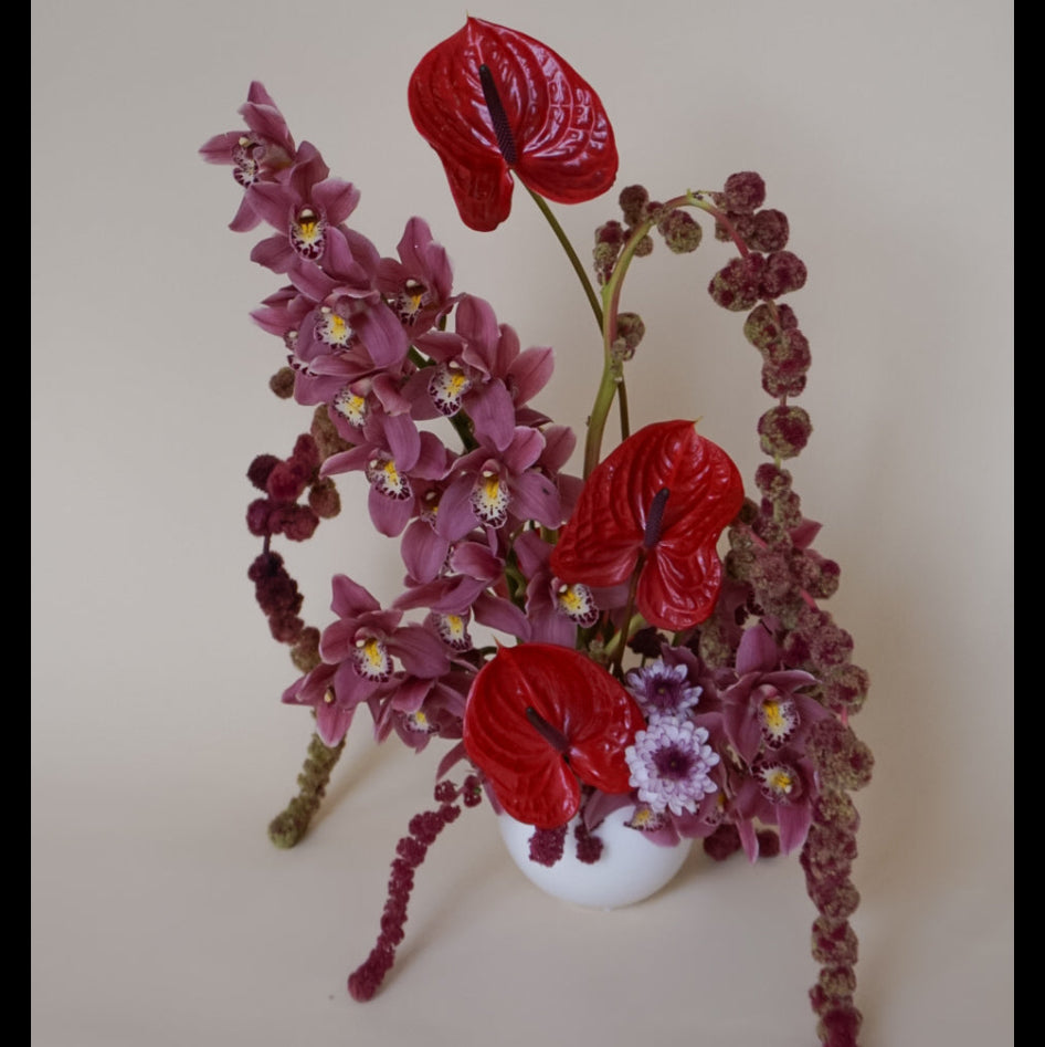 Valentine arrangement featuring anthurium, orchids, and amaranth. 