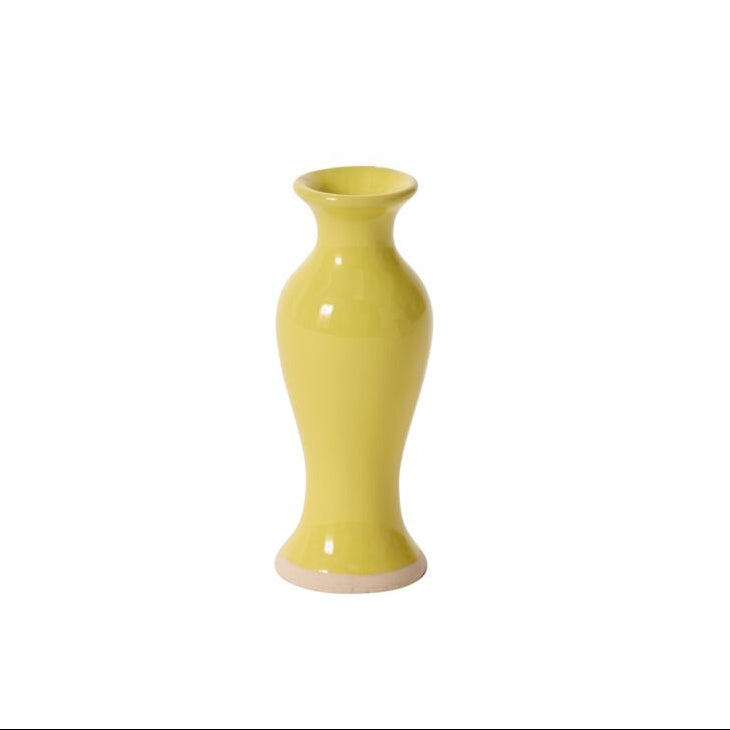 Chartreuse bud vase on a white backdrop